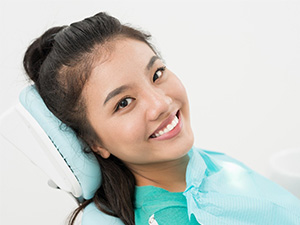 Close-up of a smiling woman in a dental chair