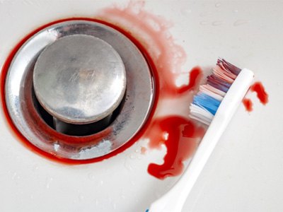 Toothbrush and blood next to sink drain