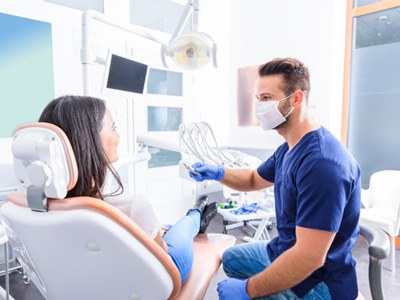 Woman at a dental appointment speaking to dentist