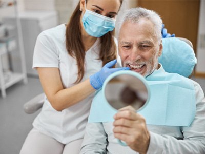 A dentist telling a patient how to care for dental implants