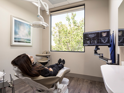 Woman leaning back in dental chair in Encinitas dental office