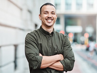 man smiling with his arms crossed