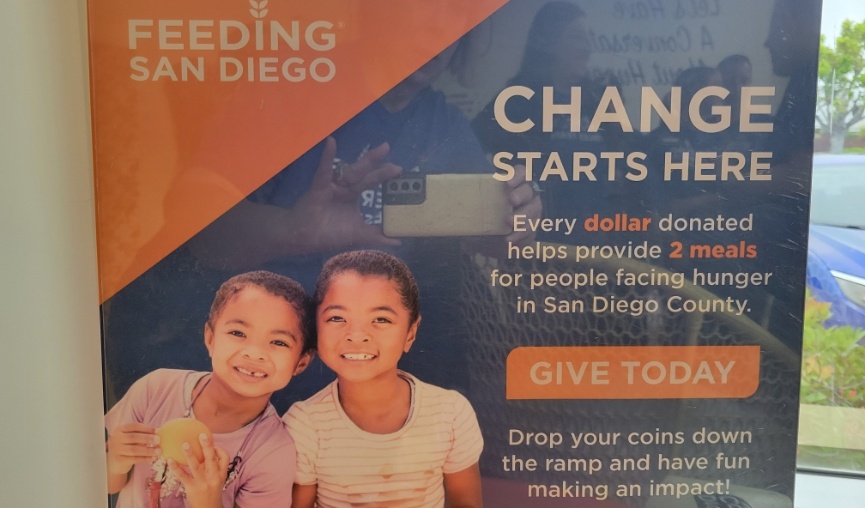 Sign for Feeding San Diego saying every dollar donated helps provide two meals to people facing hunger in San Diego County