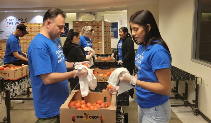 Team members washing fruits and vegetables