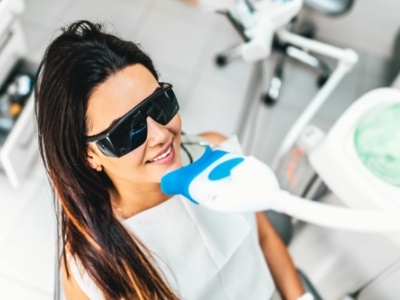 Woman getting professional teeth whitening while visiting her cosmetic dentist