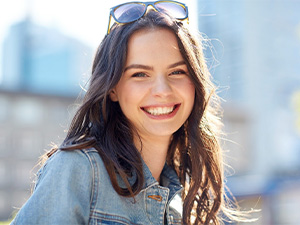 Woman with sunglasses on her head smiling