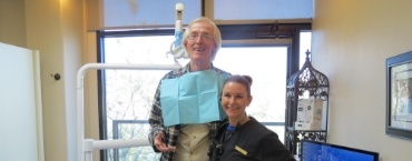 Dental team member smiling with a patient