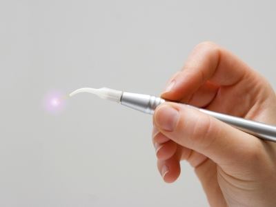 hand holding a dental soft tissue laser