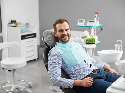 Smiling man sitting in dental chair