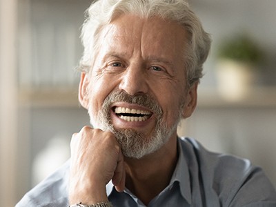 An elderly man smiling candidly at the camera