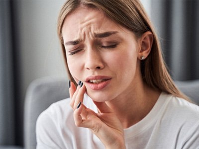 A woman touching her cheek with her fingers