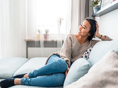 Woman smiling while relaxing at home