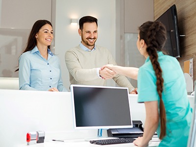 Man shaking a receptionist’s hand