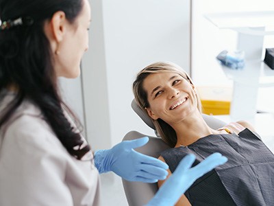Dentist discussing how a smile makeover works with patient