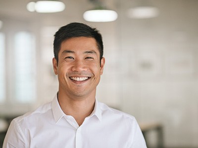 Young man smiling at work with confidence