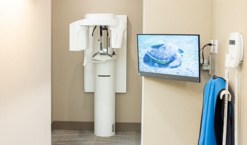 Cone beam C T scanner against white wall in dental office
