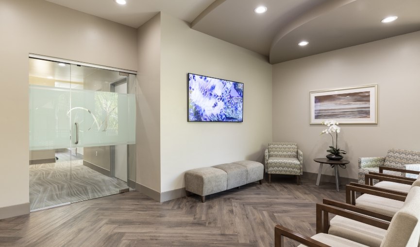 Waiting area in dental office with blue painting on wall