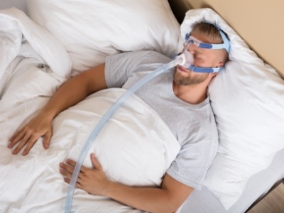 Man sleeping while wearing C P A P mask