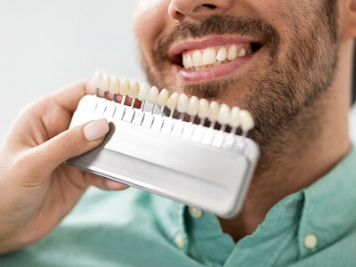 smiling man with color guide near his face